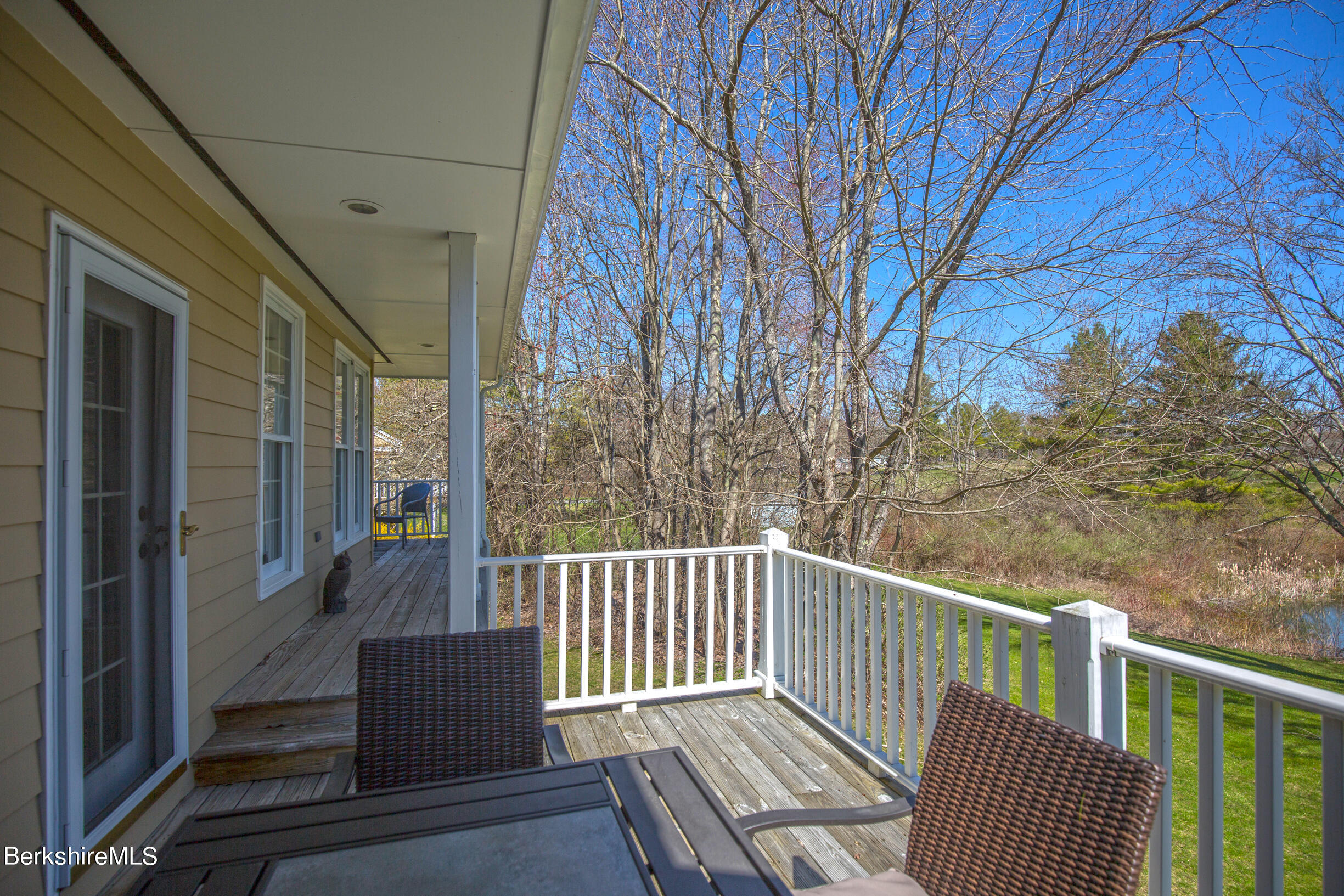 1136 Barker Road, Unit 48 Pittsfield, MA 01201 - Photo 43 of 53 a view of a balcony with wooden floor and wooden fence
