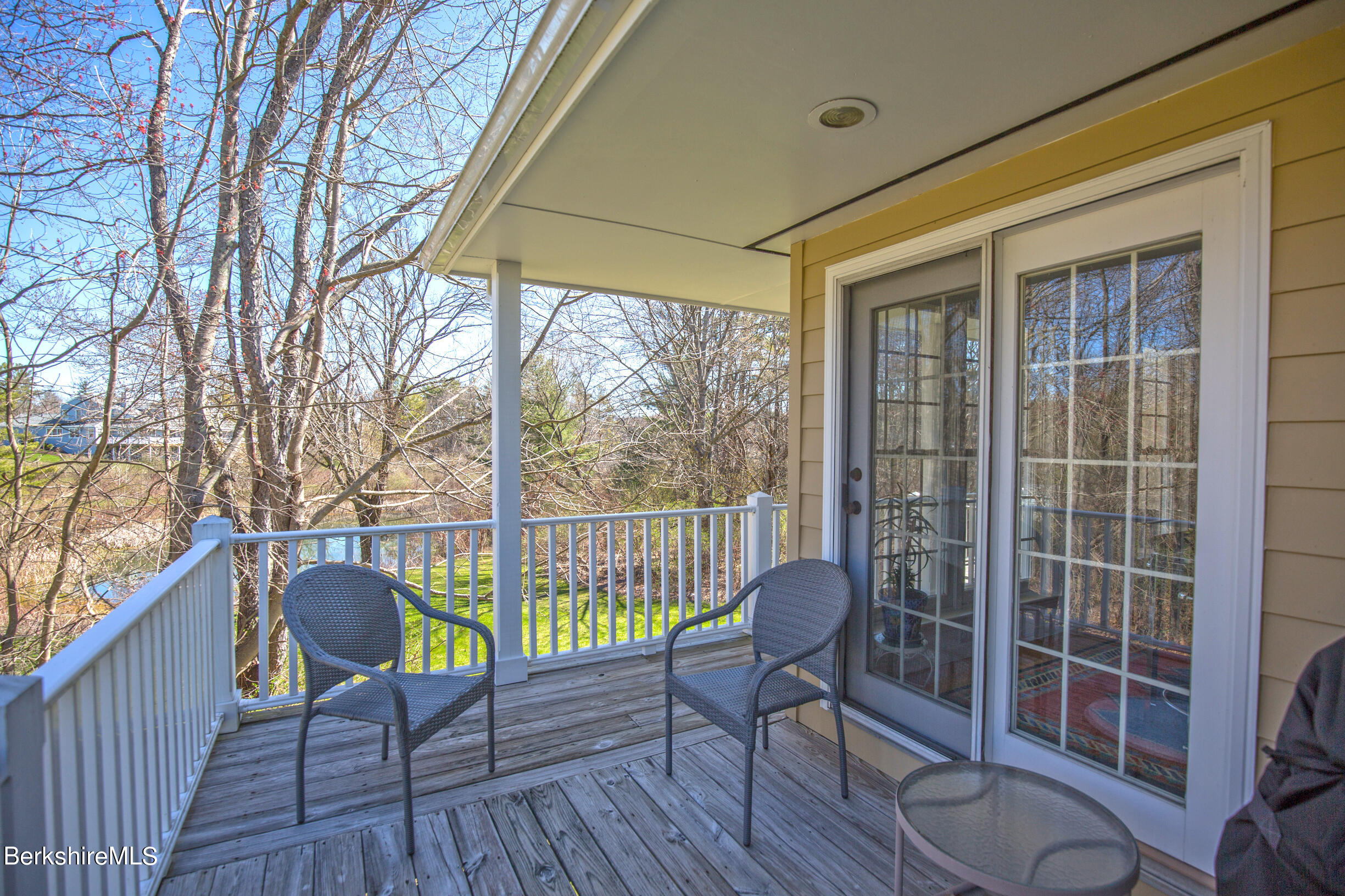 1136 Barker Road, Unit 48 Pittsfield, MA 01201 - Photo 46 of 53 a balcony with wooden floor and furniture