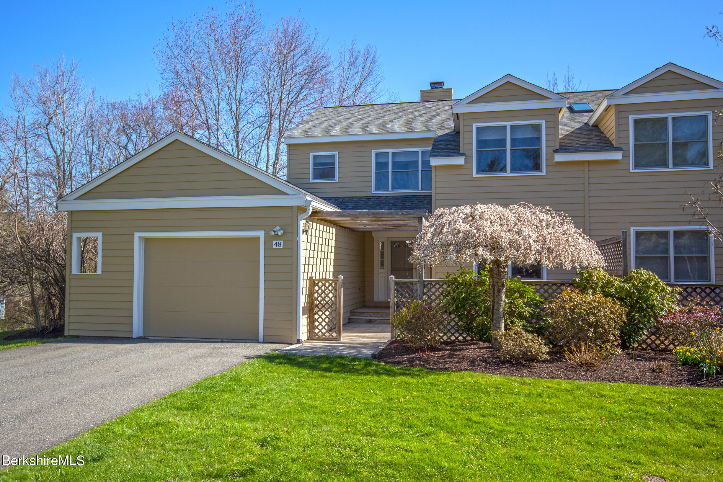 1136 Barker Road, Unit 48 Pittsfield, MA 01201 - Photo 52 of 53 a front view of a house with a yard and garage