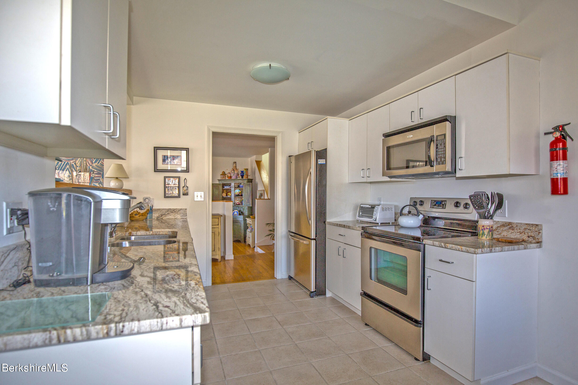 1136 Barker Road, Unit 48 Pittsfield, MA 01201 - Photo 6 of 53 a view of a kitchen with refrigerator and microwave
