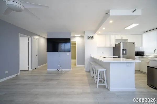 a large kitchen with a refrigerator and a sink