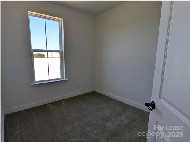 a view of a hallway with a wooden door