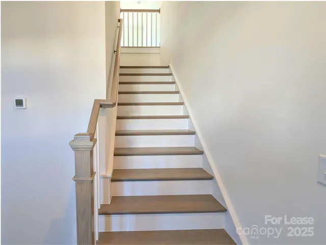 a kitchen with stainless steel appliances granite countertop a kitchen island a stove a sink a counter top space and cabinets