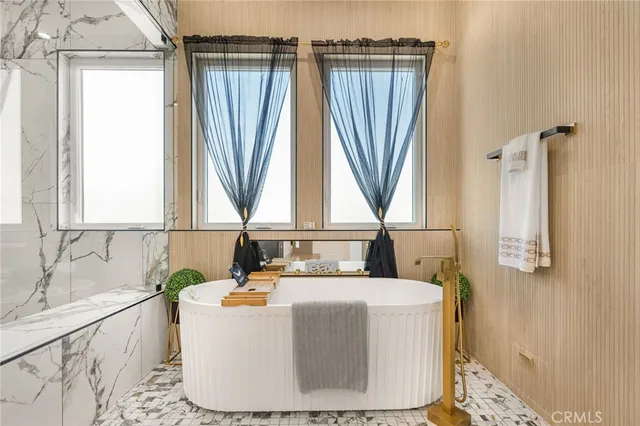 a bedroom with a bed and a flat tv screen on the dresser