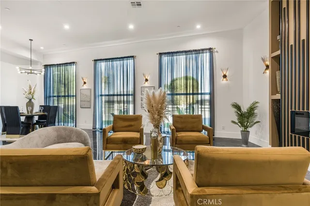 a kitchen with stainless steel appliances granite countertop a sink a stove and a wooden floors