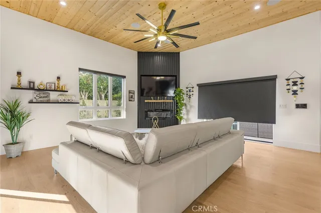 an aerial view of residential houses with outdoor space and trees