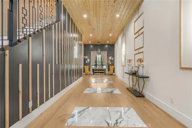 a view of a livingroom with wooden floor and furniture
