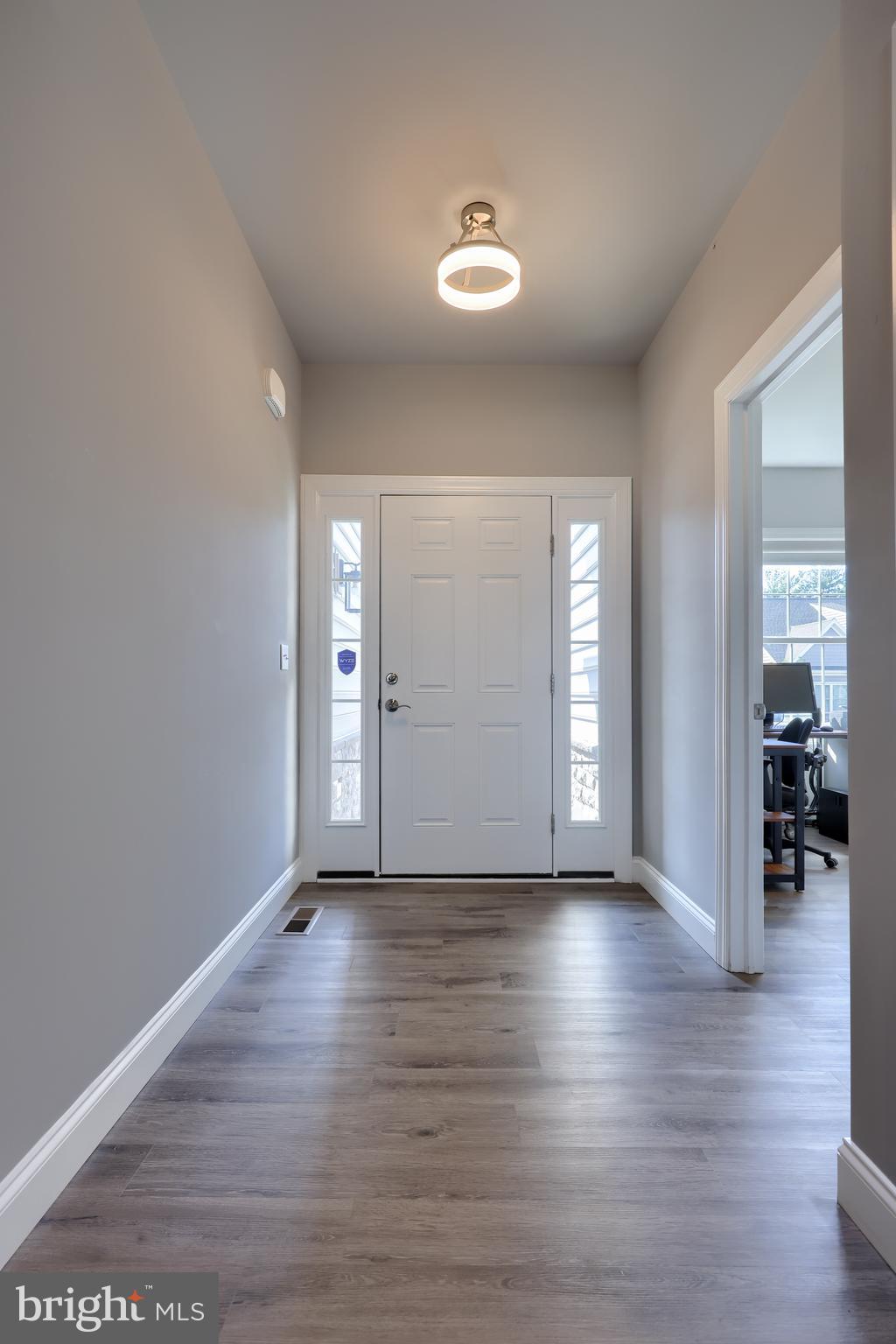 208 Buckton Drive Lititz, PA 17543 - Photo 7 of 25 a view of an empty room with wooden floor and a window