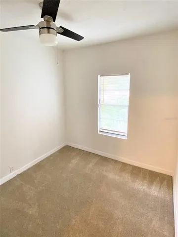 an empty room with a empty space and windows