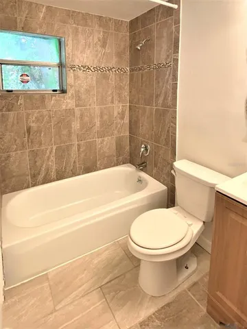 a bathroom with a toilet and a bath tub