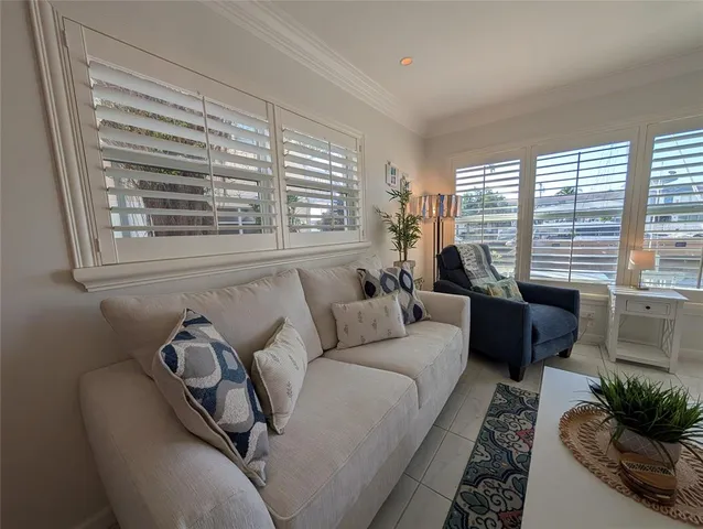 a living room with furniture and a floor to ceiling window
