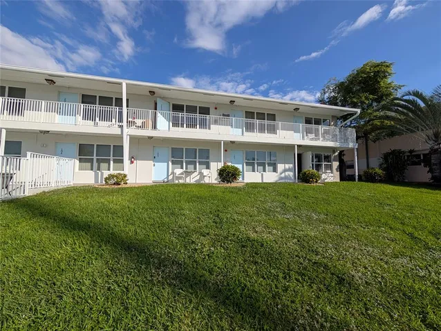 a front view of a building with a yard