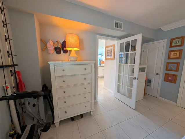 a view of walk in closet with clothes shoes and a mirror