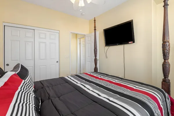 a bedroom with a bed and a flat screen tv