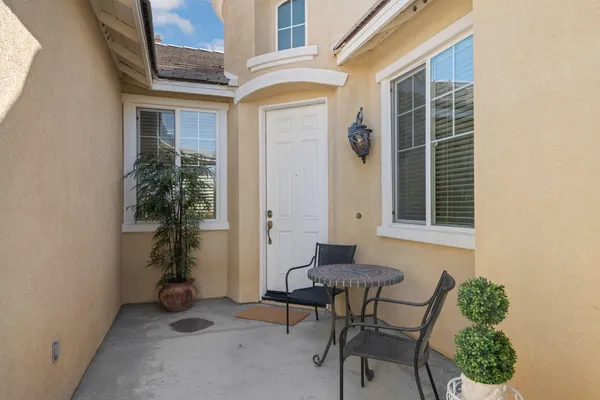 a view of house with backyard and outdoor seating