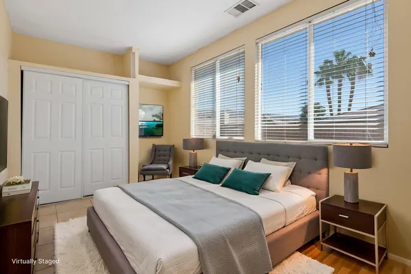 a bedroom with a bed and a flat tv screen
