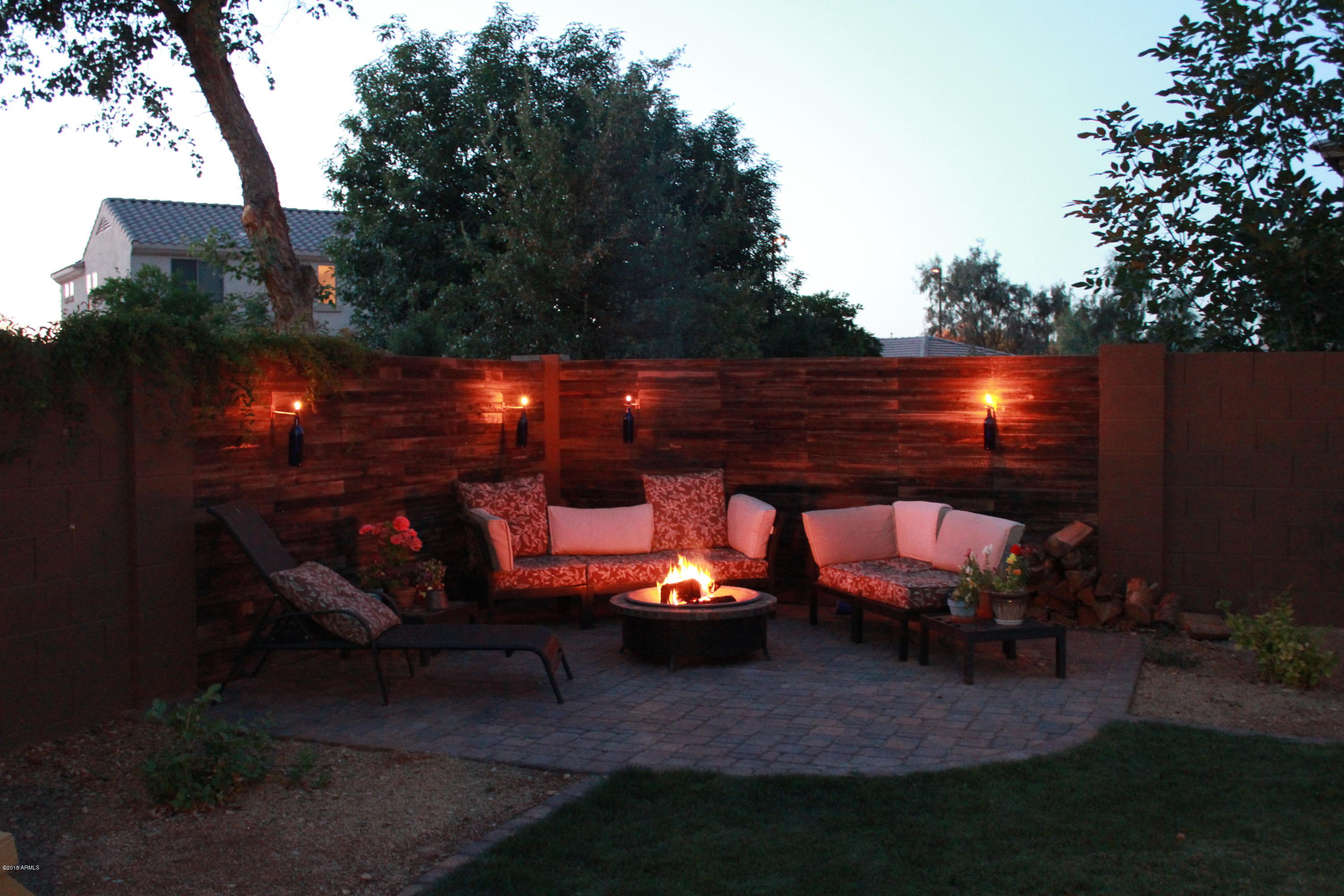 4720 East Timberline Road Gilbert, AZ 85297 - Photo 1 of 39 a view of a chairs and fire pit in a backyard