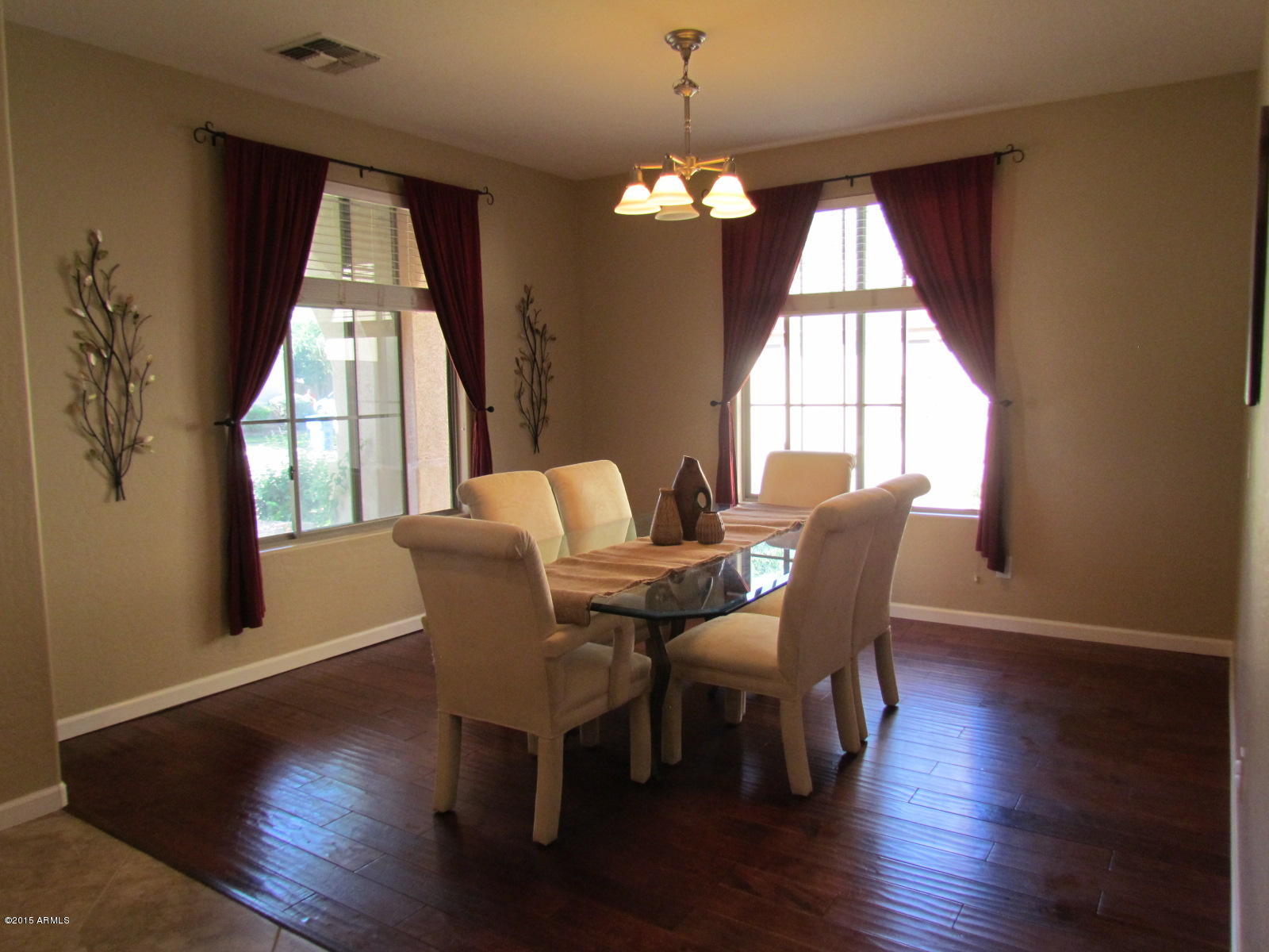 4720 East Timberline Road Gilbert, AZ 85297 - Photo 3 of 39 a view of a dining room with furniture window and wooden floor