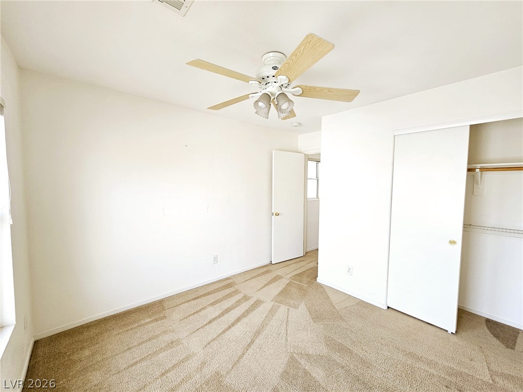 1663 Lefty Garcia Way Henderson, NV 89002 - Photo 18 of 31 Well-lit sleeping quarters with plush carpeting and convenient built-in closet storage.