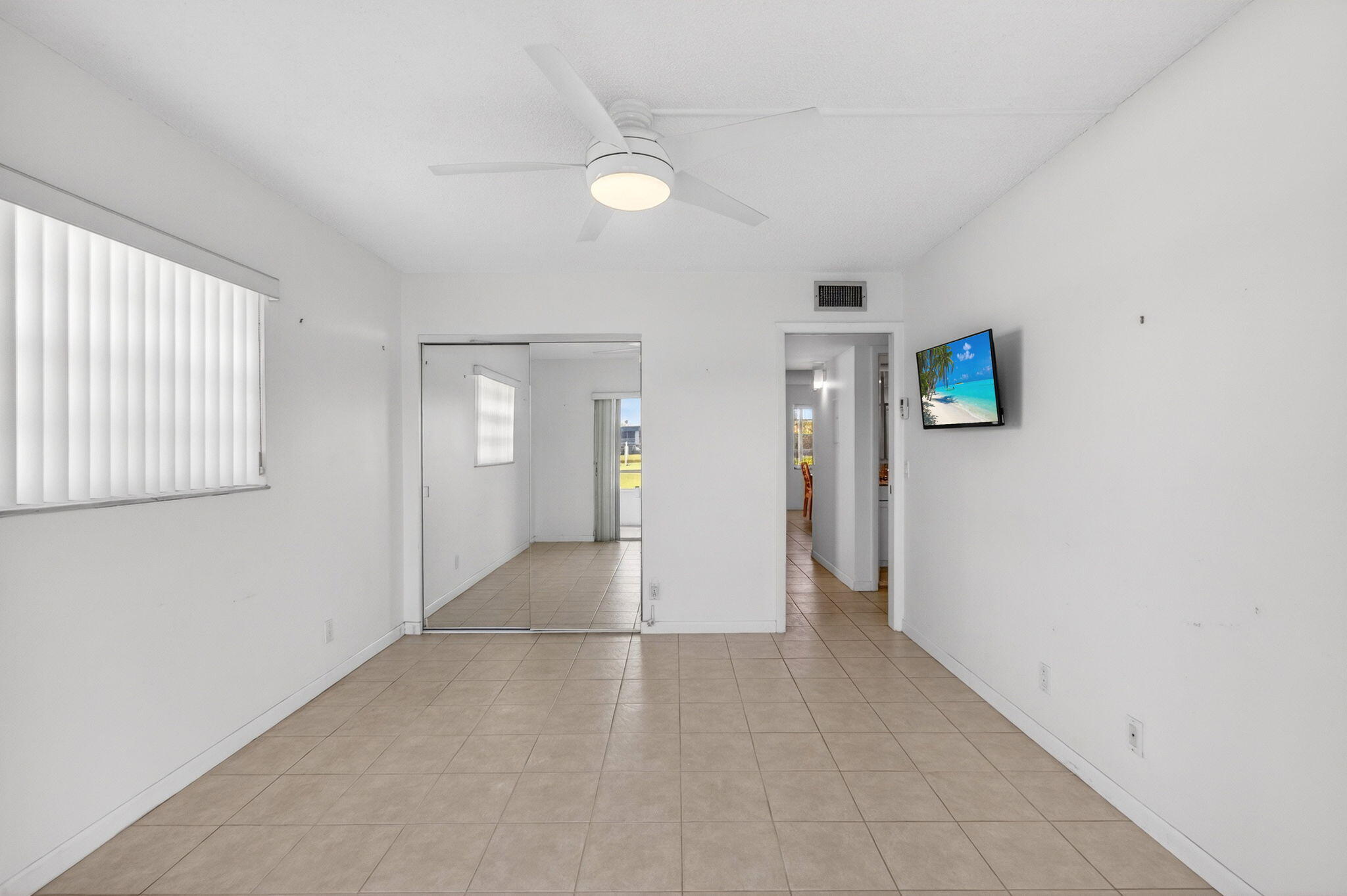 167 Normandy Lane, Unit D Delray Beach, FL 33484 - Photo 25 of 46 Tiled Bedroom with Fan and TV