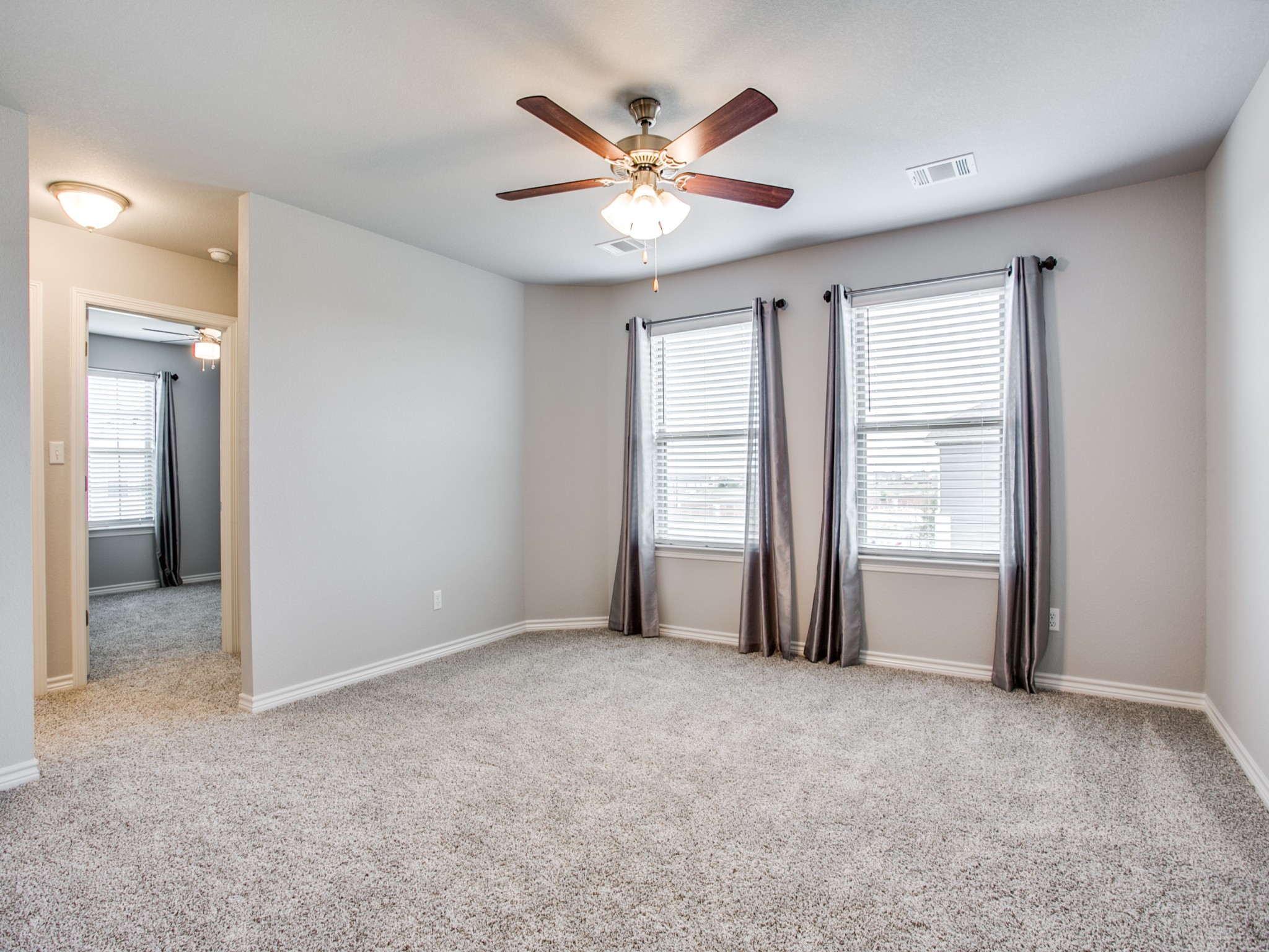 508 Rearing Mare Pass Georgetown, TX 78626 - Photo 10 of 26 Empty room featuring ceiling fan, carpet, and healthy amount of natural light