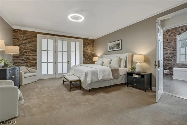 a bedroom with bed and chair