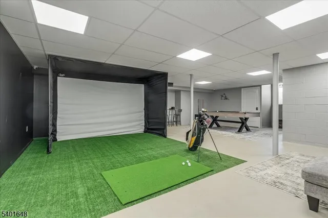 a reading room with furniture and a floor to ceiling window