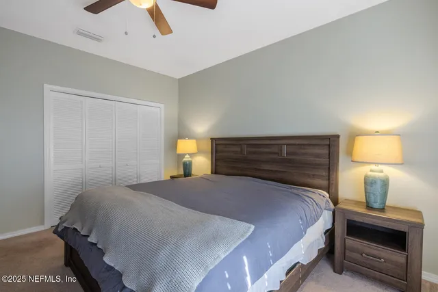 a bedroom with a bed and a lamp