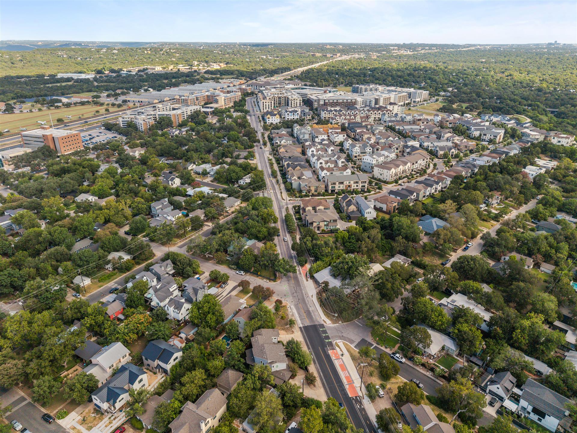 3806 Bull Creek Road, Unit B Austin, TX 78731 - Photo 31 of 37 A high-altitude perspective showcases a vibrant, tree-lined neighborhood with winding roads and a welcoming community atmosphere. This home is mere blocks from The Grove, offering easy access to a beautiful park, an array of restaurants, and premier shopping.