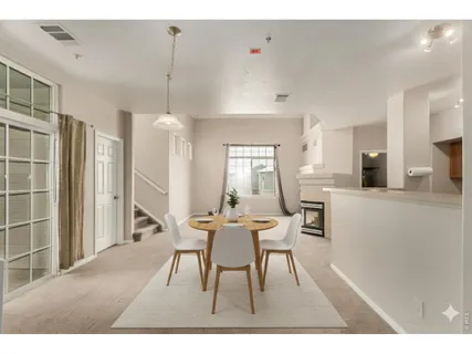 a dining room with furniture and window