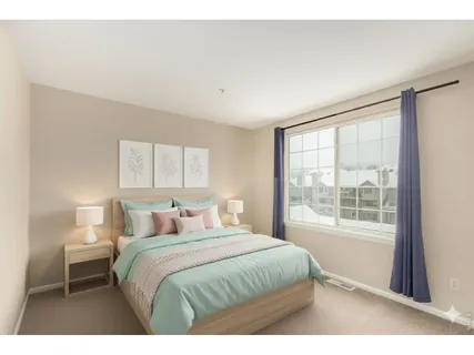 a bedroom with a large bed and a window