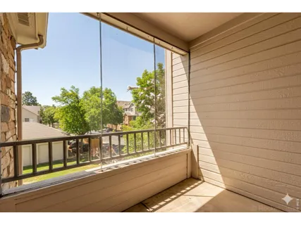 a view of balcony with wooden floor