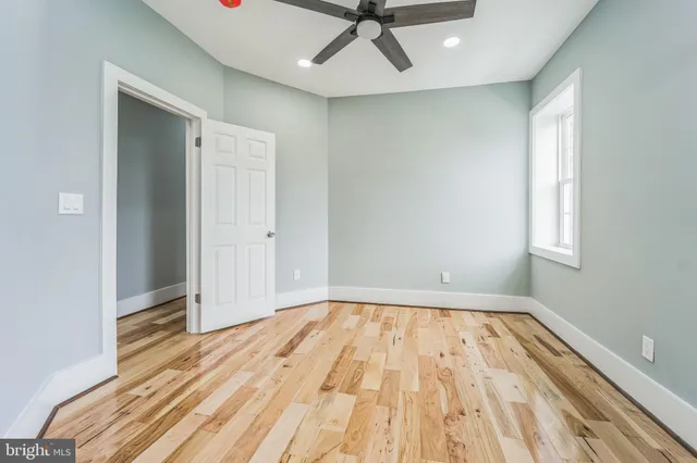 a view of a room with wooden floor and white walls