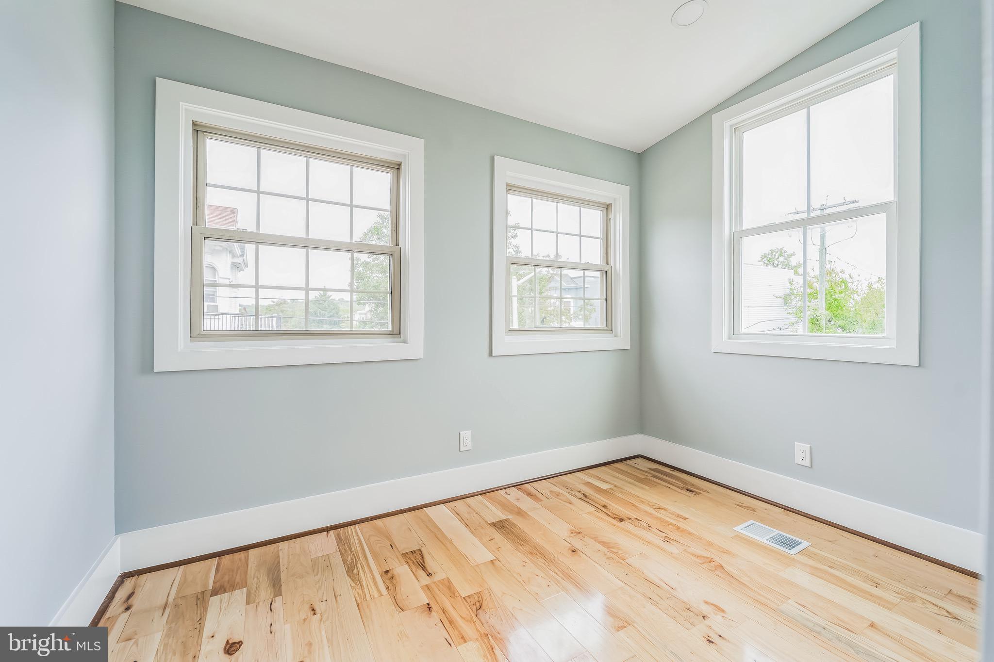 1036 Poplar Grove Street Baltimore, MD 21216 - Photo 22 of 24 a view of an empty room with wooden floor and a window