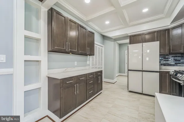 a kitchen with a refrigerator sink and cabinets