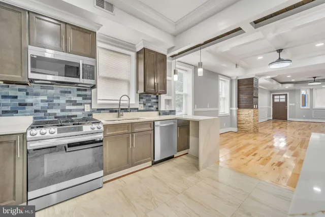 a kitchen with a stove sink and cabinets