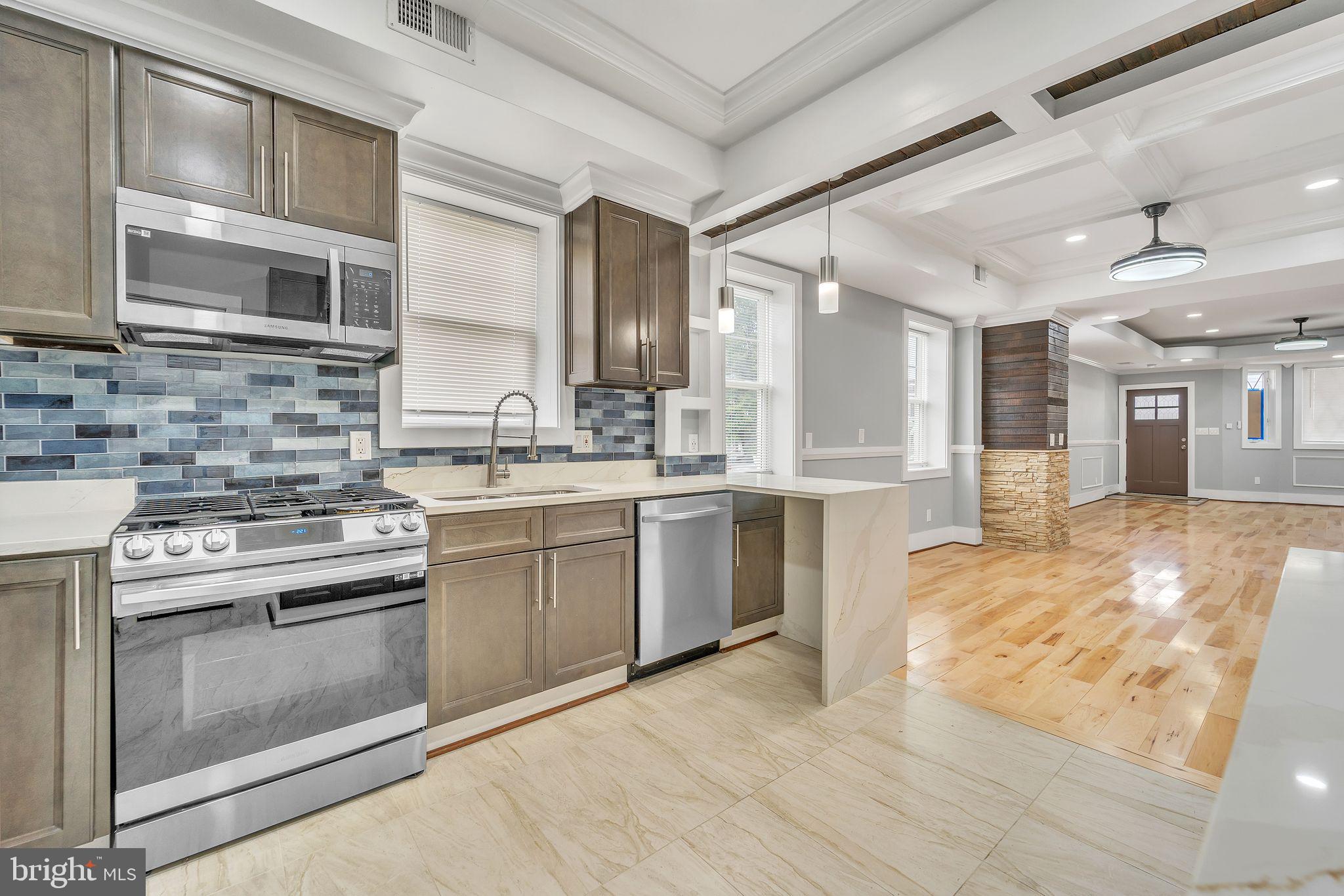1036 Poplar Grove Street Baltimore, MD 21216 - Photo 8 of 24 a kitchen with a stove sink and cabinets