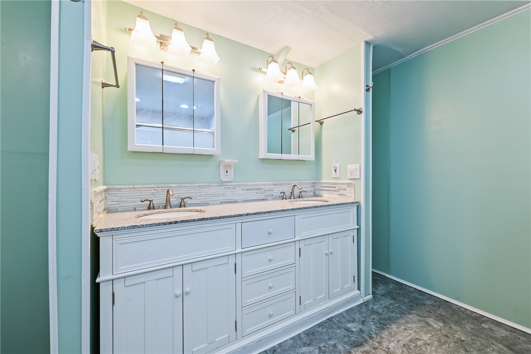 3475 Adobe Road Golden Valley, AZ 86413 - Photo 29 of 71 Full bathroom featuring double vanity and decorative backsplash