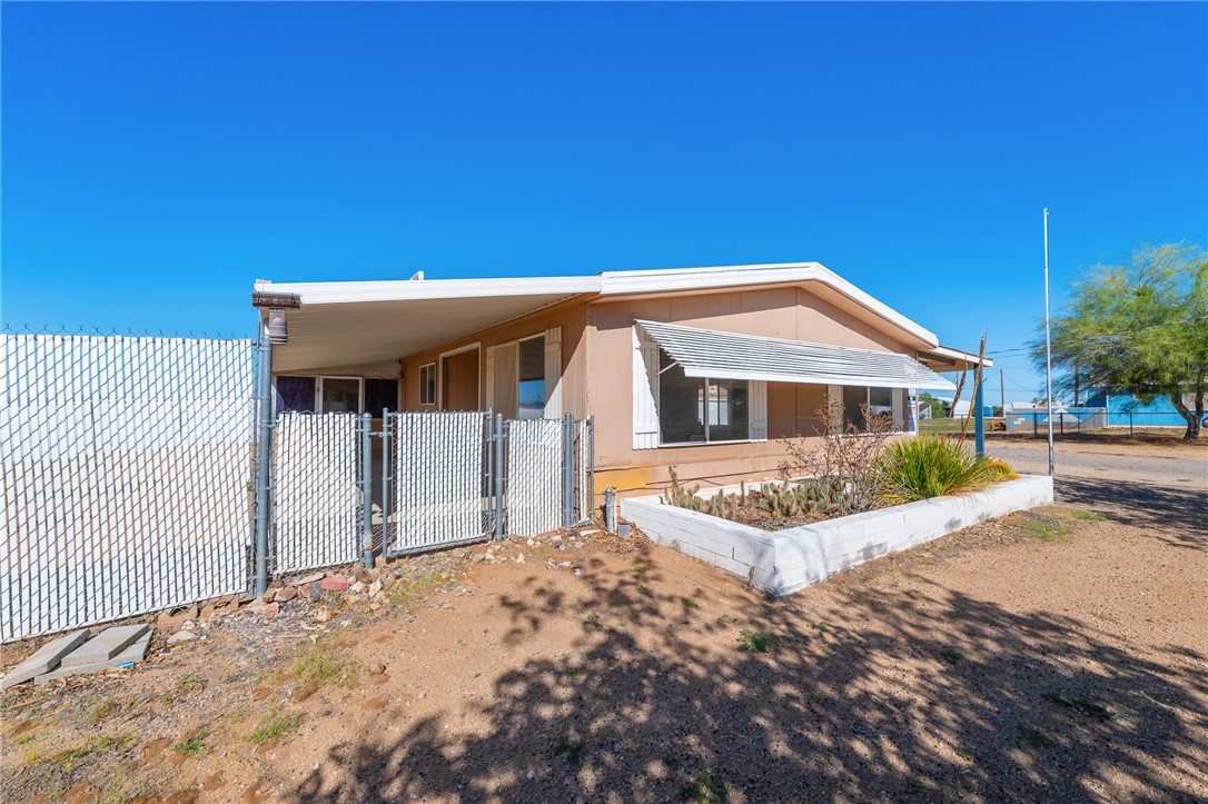 3475 Adobe Road Golden Valley, AZ 86413 - Photo 3 of 71 View of front of home with a gate