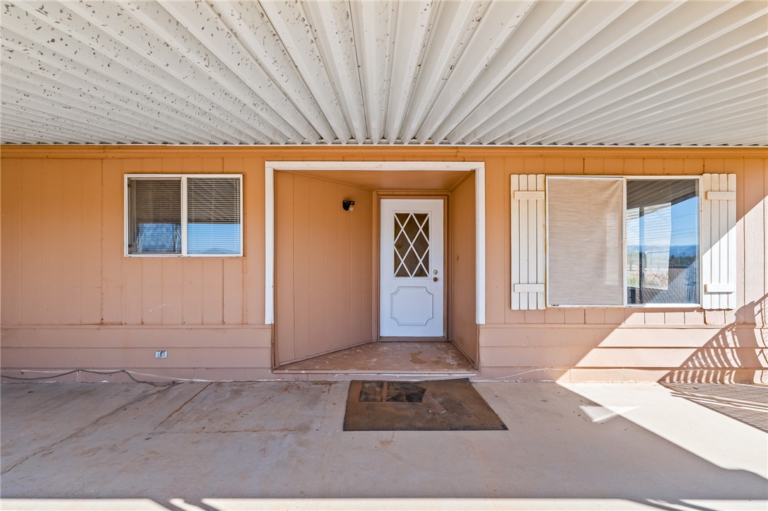 3475 Adobe Road Golden Valley, AZ 86413 - Photo 44 of 71 View of exterior entry featuring a metal roof