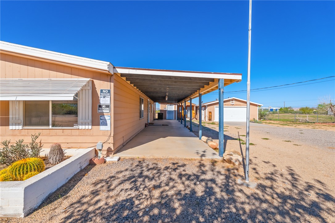 3475 Adobe Road Golden Valley, AZ 86413 - Photo 45 of 71 View of patio / terrace featuring an attached carport and an outdoor structure