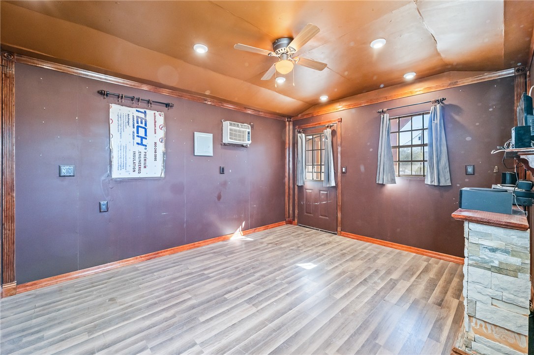 3475 Adobe Road Golden Valley, AZ 86413 - Photo 50 of 71 Entryway with vaulted ceiling, wood finished floors, a ceiling fan, and a wall mounted AC