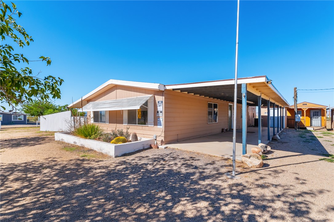 3475 Adobe Road Golden Valley, AZ 86413 - Photo 5 of 71 View of home's exterior with a carport, a patio, and driveway
