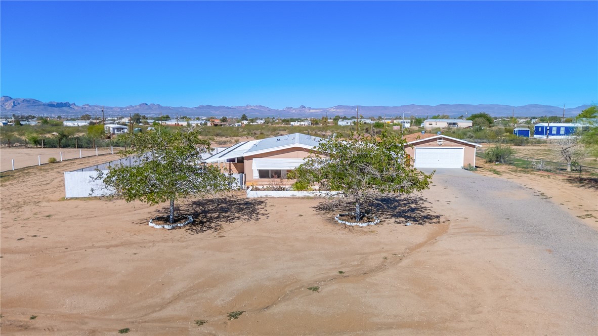 3475 Adobe Road Golden Valley, AZ 86413 - Photo 60 of 71 View of front of property with a mountain view, driveway, and a detached garage