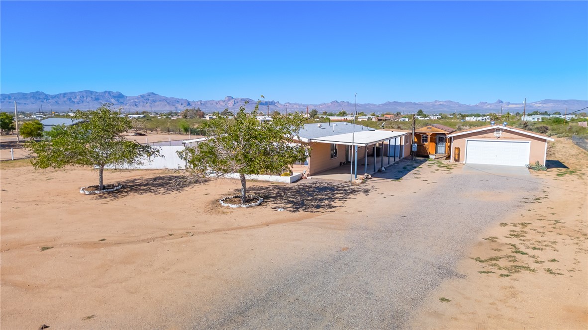 3475 Adobe Road Golden Valley, AZ 86413 - Photo 61 of 71 View of front facade with a mountain view, a garage, and driveway