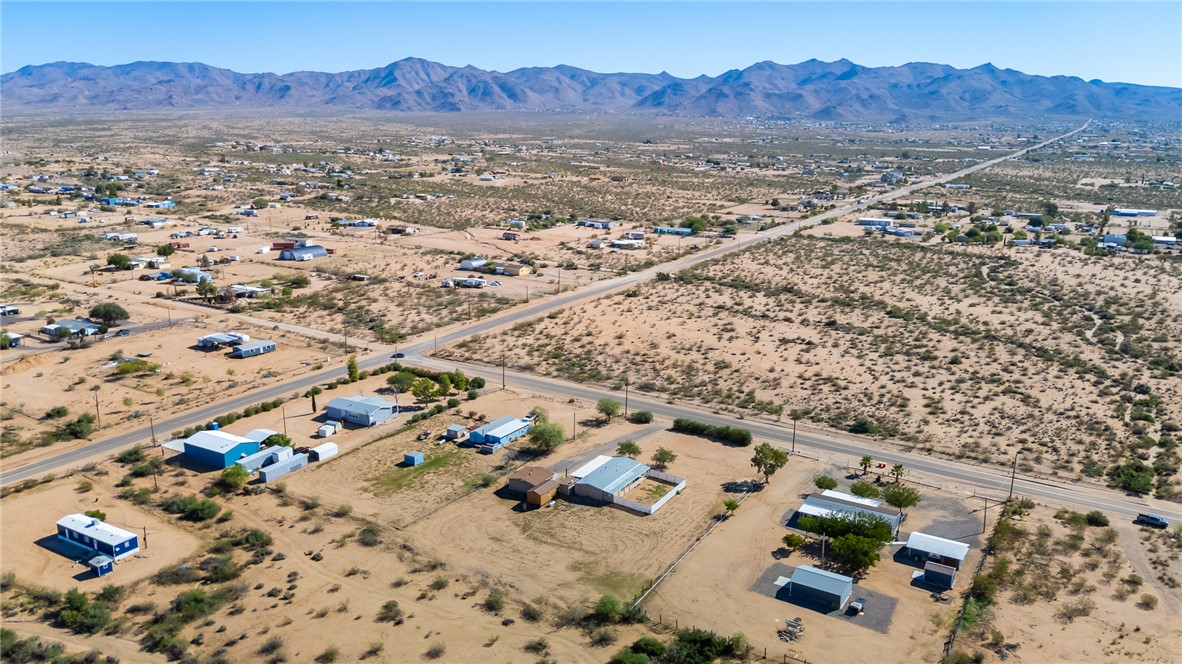 3475 Adobe Road Golden Valley, AZ 86413 - Photo 65 of 71 Aerial view of sparsely populated area featuring a mountain backdrop