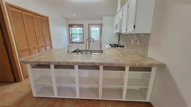 a view of a kitchen counter space and windows