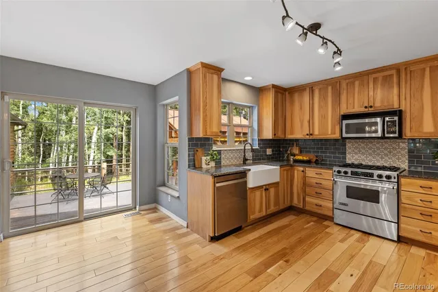 a kitchen with a stove a sink and a refrigerator
