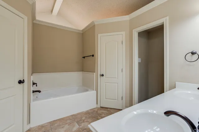 a bathroom with a tub shower and a sink