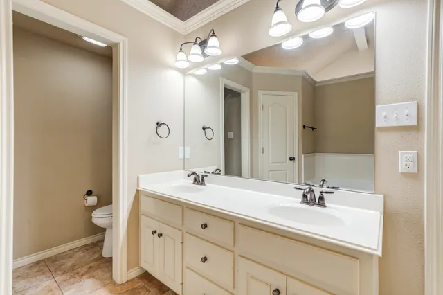 a bathroom with a sink double vanity and a mirror